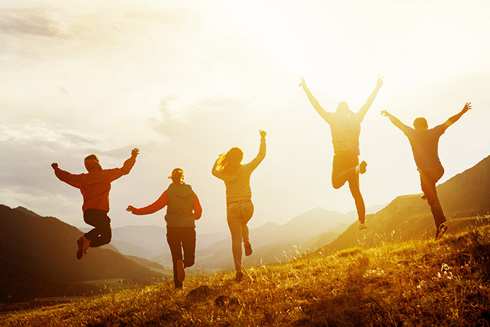 People jumping together outdoors