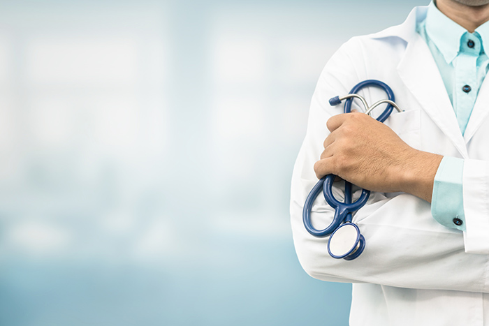 Doctor holding a stethoscope with crossed arms